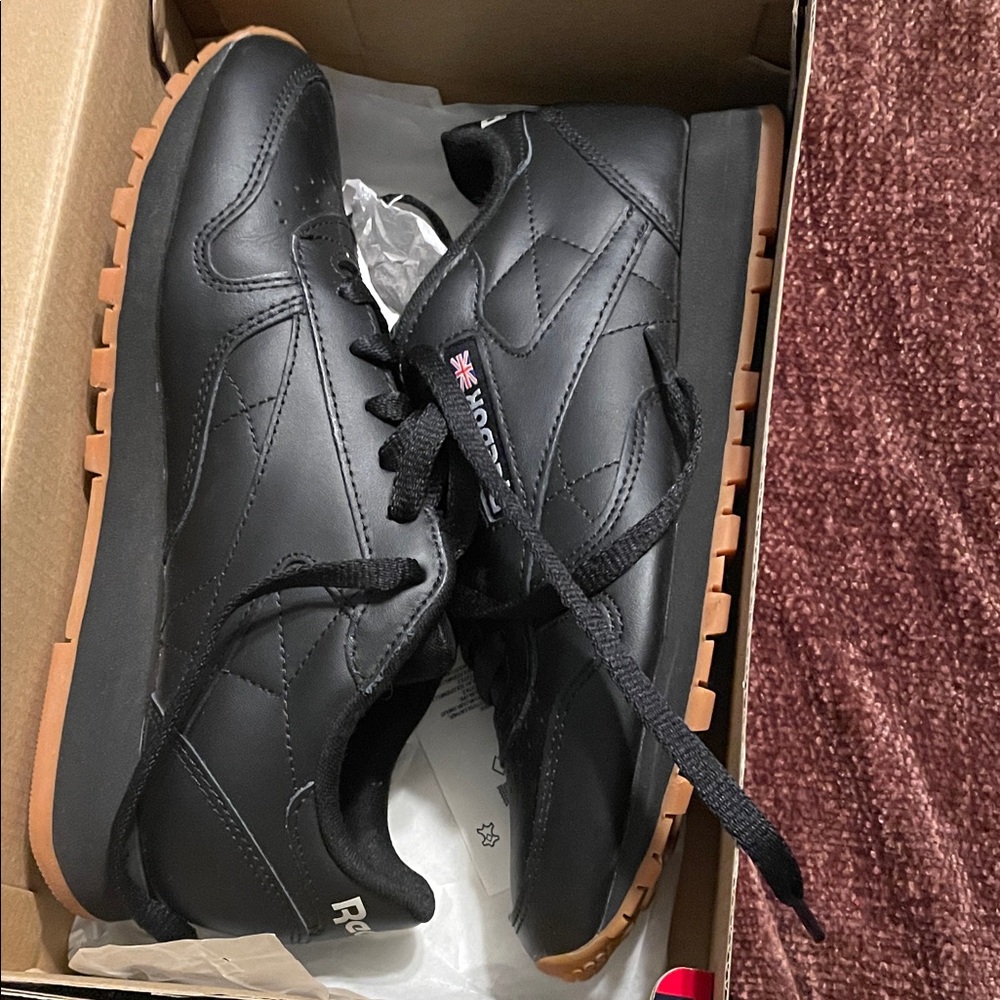 Reebok women’s Black Roma Sneakers